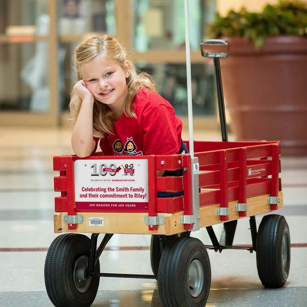 Girl in Riley red wagon