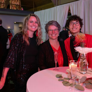 Riley supporters in front of a table at the Riley Red event