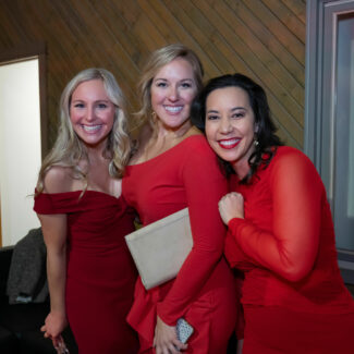 Three women Riley supporters posing for photo at Riley Red event