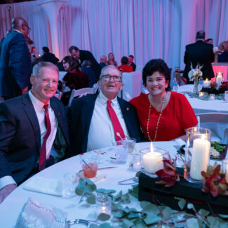 Liz Elkas sitting with supporters at Riley Red event