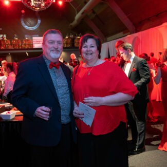 Two Riley supporters posing for photo at Riley Red event