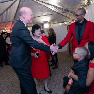 Riley Red event, Gil Peri shaking hands with attendees.