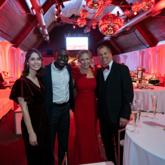 Group of four posing at the Riley Red event